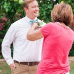 pinning a boutonniere on a groom