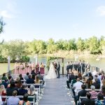 Wedding on the Windmill Winery dock with decorated arch and 13 attendants